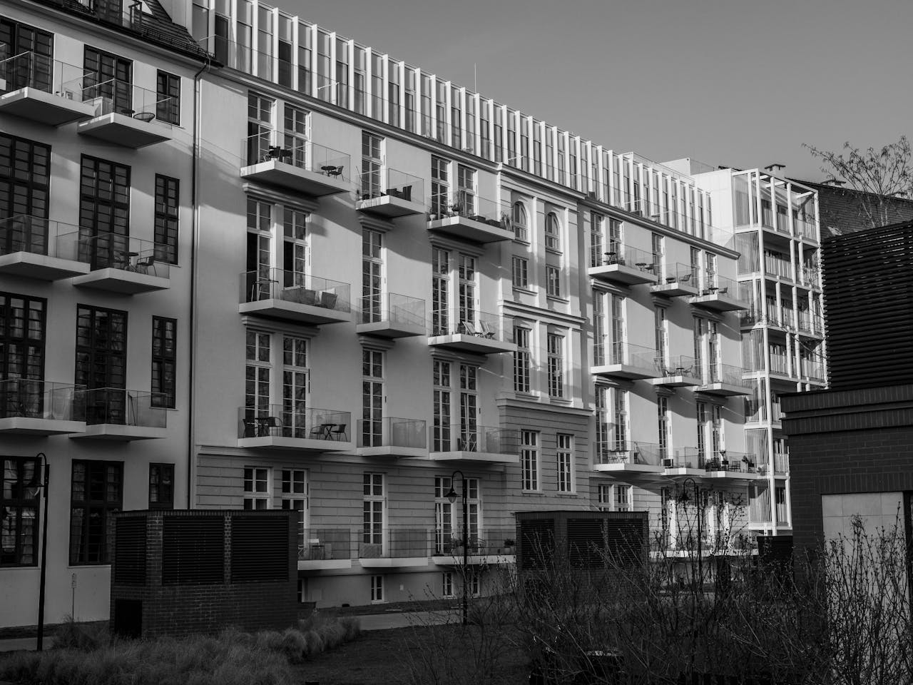 Monochrome view of a modern apartment building with balconies.